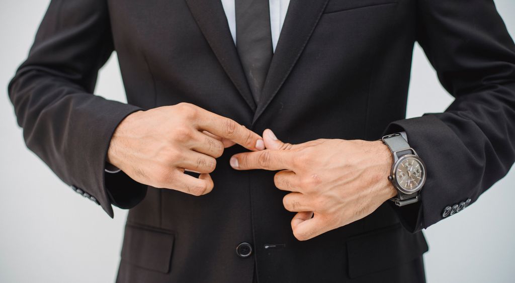 Man adjusting a well-fitted suit jacket