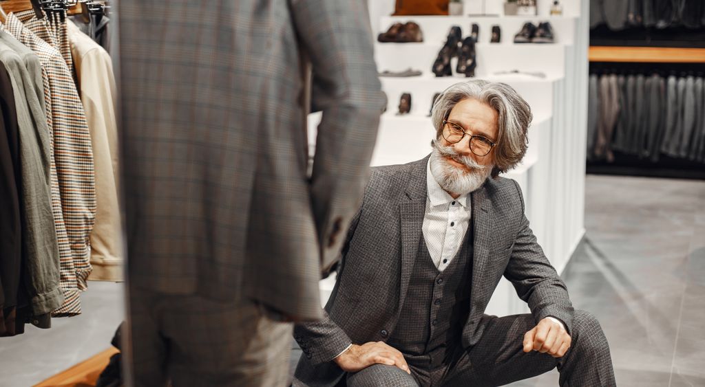Man choosing an elegant suit in a tailoring store