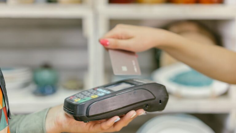 Credit Cards That Waive the Fuel Surcharge at the Pump A contactless card being tapped on a payment terminal