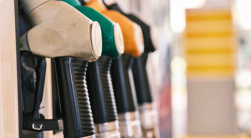 A close-up row of fuel pump nozzles