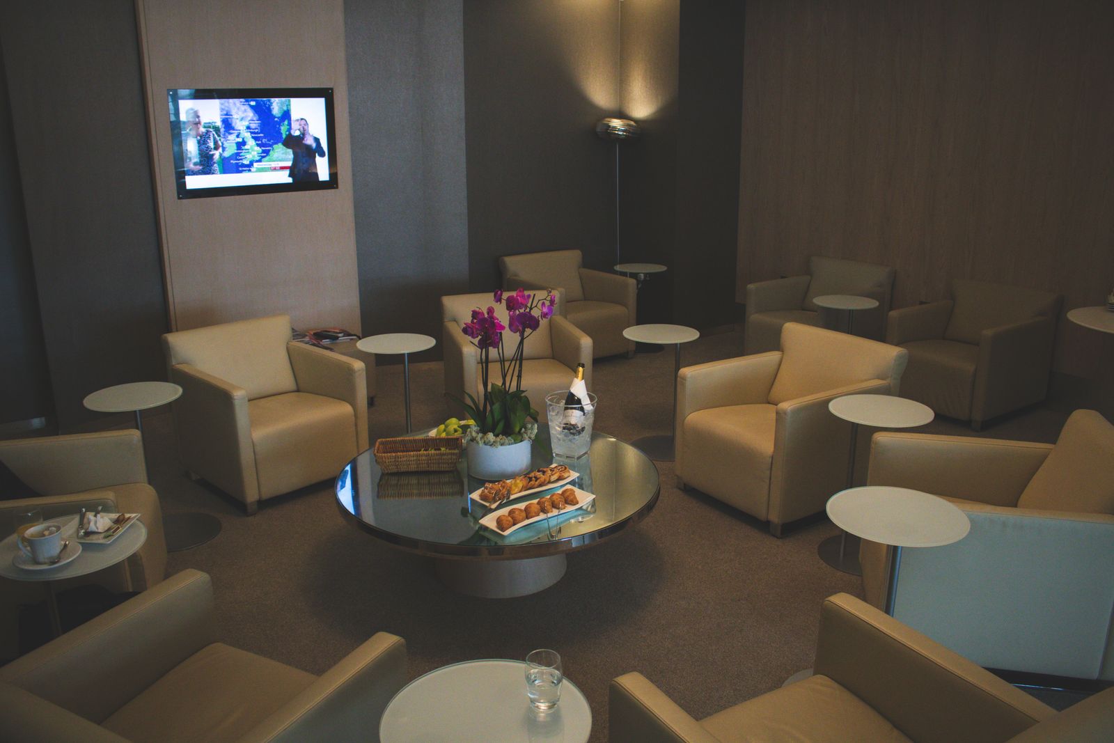 Quiet airport lounge with armchairs and low tables