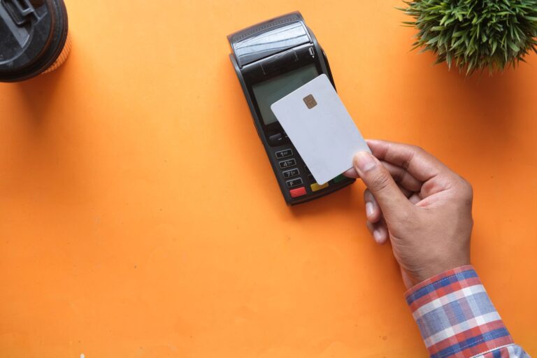 Unbranded white card held at a card machine