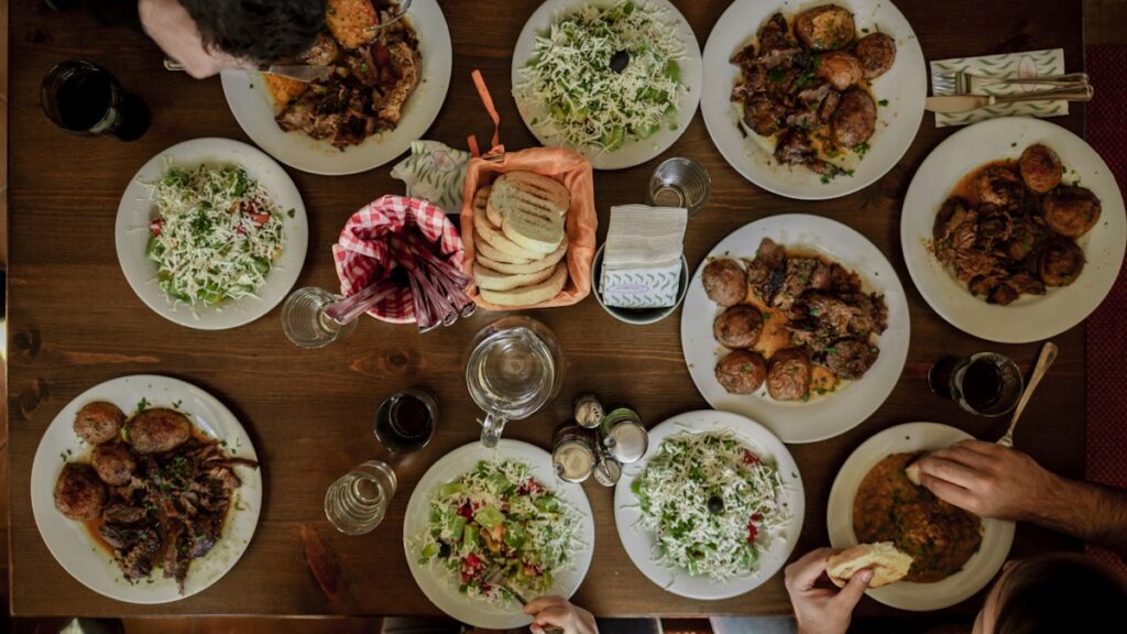 Restaurant Offers You Can Use on an Ordinary Weeknight Overhead view of a shared restaurant table with several dishes