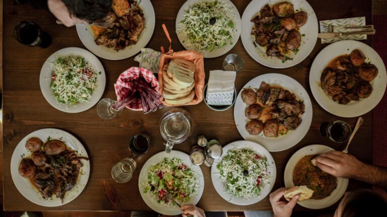 Restaurant Offers You Can Use on an Ordinary Weeknight Overhead view of a shared restaurant table with several dishes