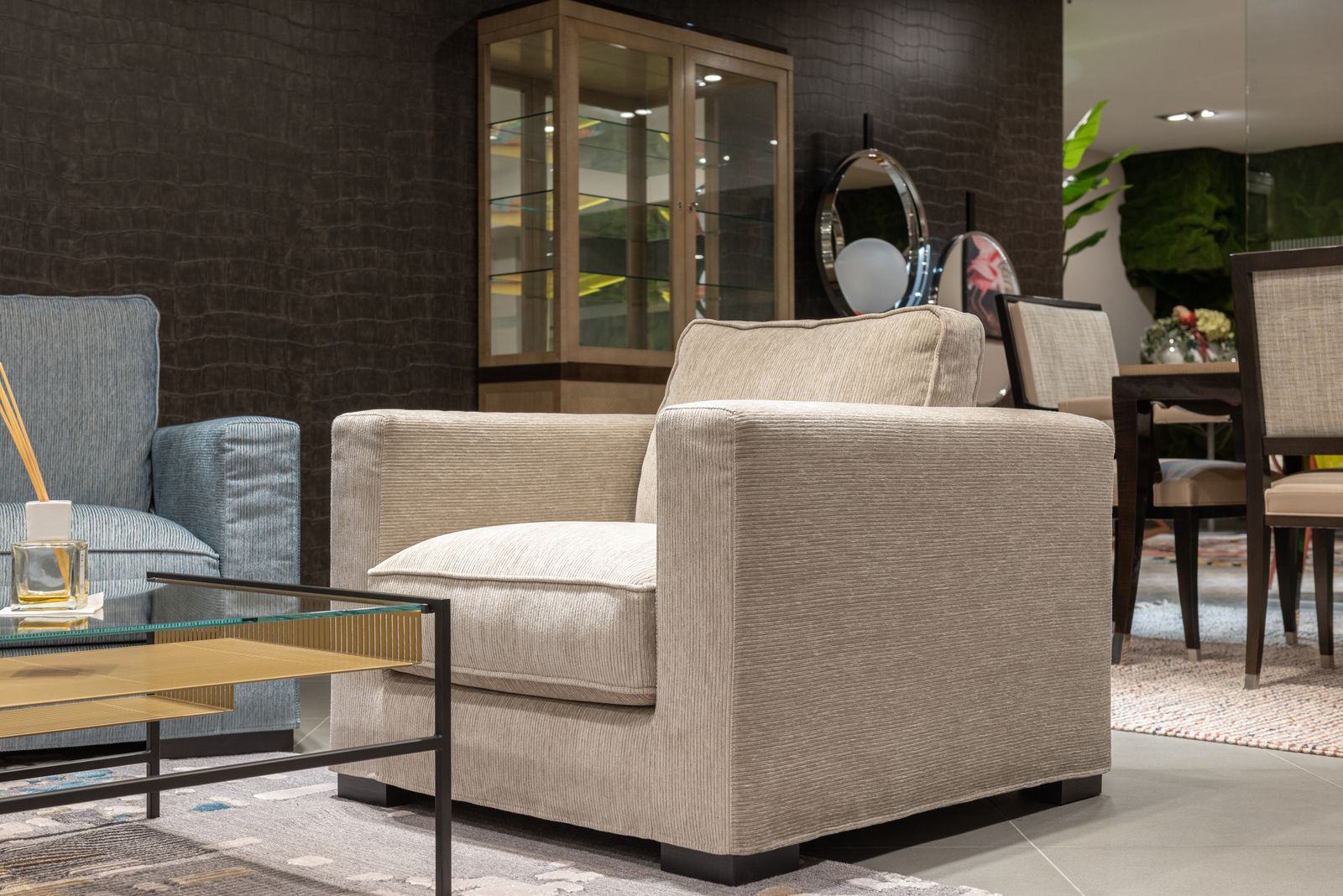 A cream upholstered armchair in a living room