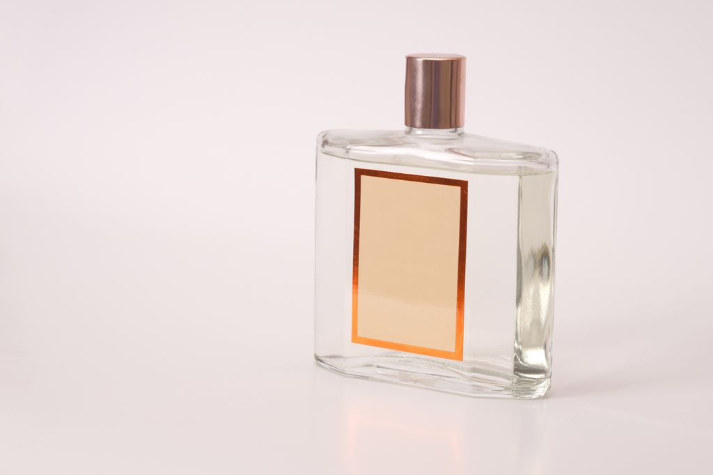 Clear glass fragrance bottle with a blank label