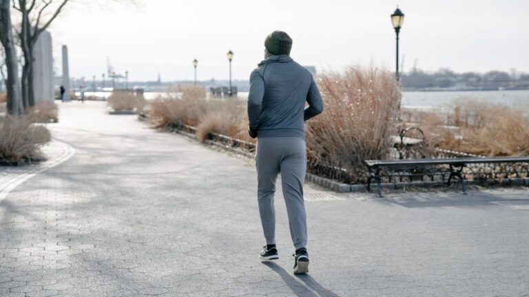 Running Clothes Designed for Cold Morning Workouts A runner from behind in full winter running kit