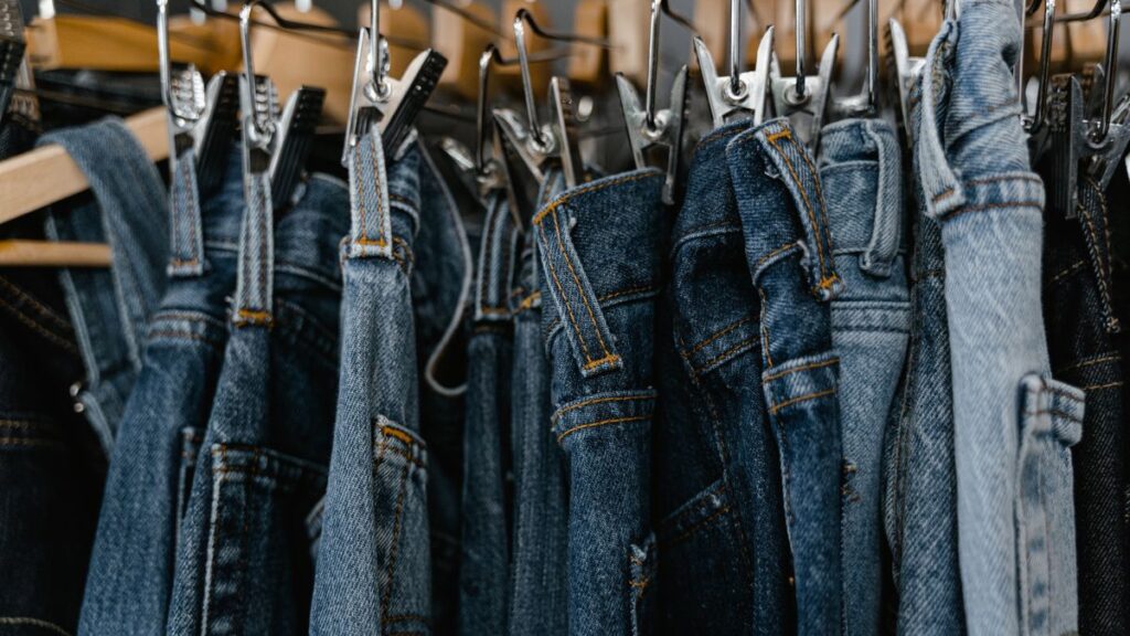 Selvedge Jeans That Fit Into Your Everyday Wardrobe A rail of denim jeans with contrast stitching